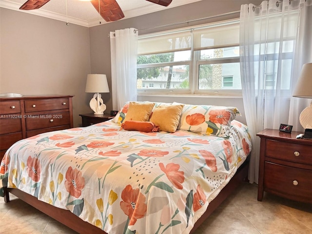 bedroom with light tile patterned floors, ornamental molding, and ceiling fan