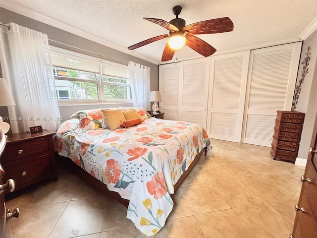 tiled bedroom featuring a textured ceiling, ornamental molding, and ceiling fan