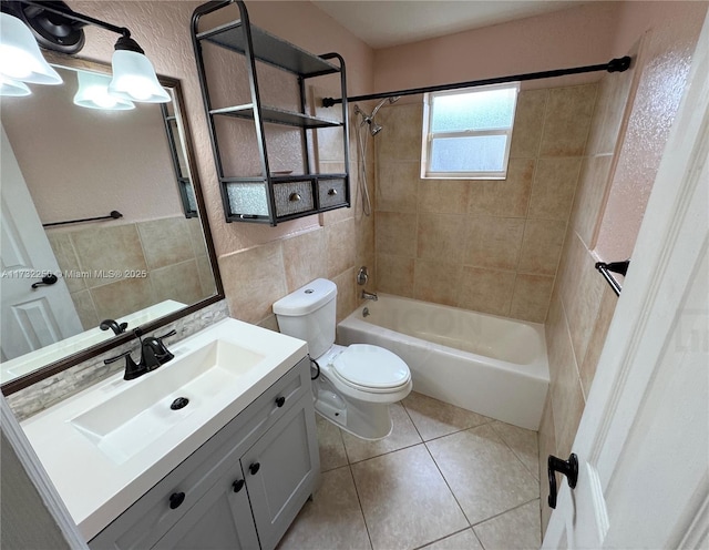 full bathroom with tile walls, tiled shower / bath combo, vanity, tasteful backsplash, and toilet