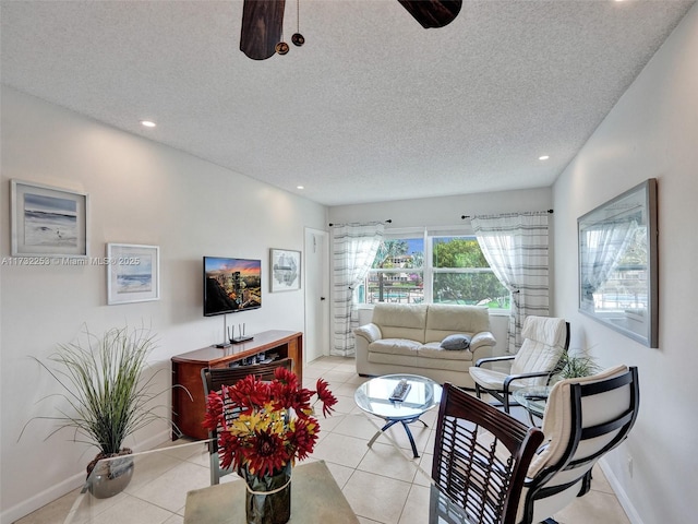 tiled living room featuring a textured ceiling