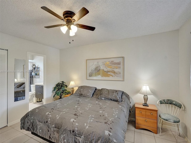 tiled bedroom featuring ceiling fan, ensuite bathroom, a closet, and a textured ceiling