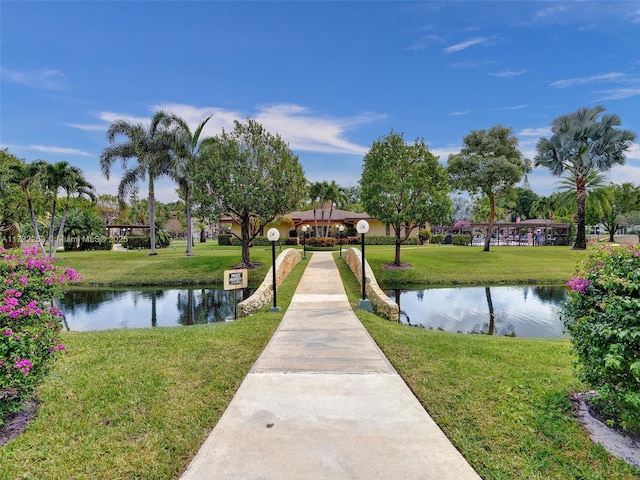 view of community featuring a water view and a yard