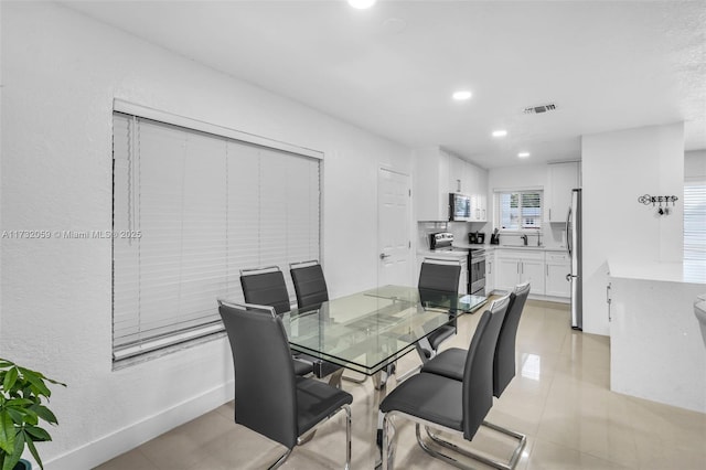 dining area featuring light tile patterned flooring