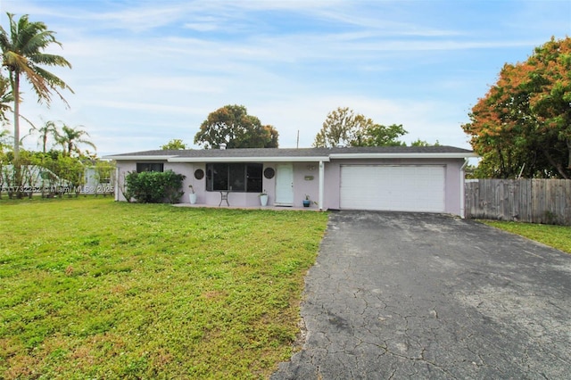 single story home with a garage and a front lawn