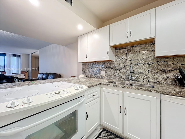 kitchen with sink, white electric range oven, light stone counters, tasteful backsplash, and white cabinets