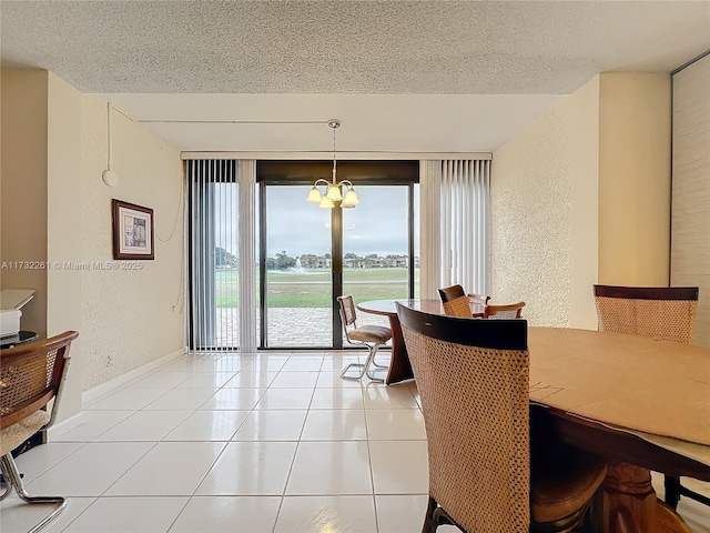 dining room featuring light tile patterned floors, a notable chandelier, and a textured ceiling