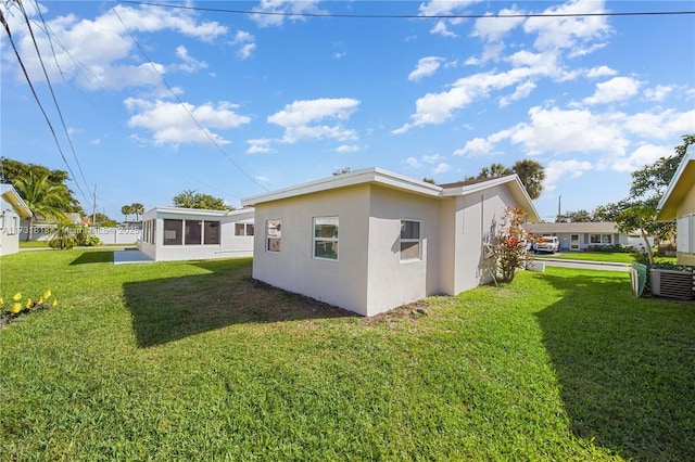 back of property featuring a lawn