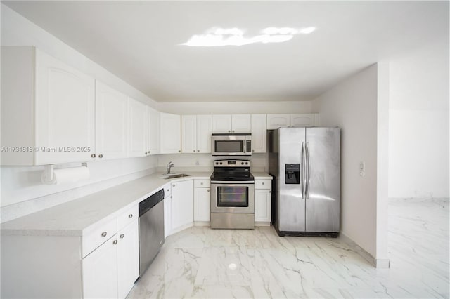 kitchen with sink, white cabinets, and appliances with stainless steel finishes