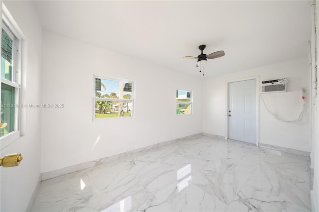 empty room with ceiling fan, a healthy amount of sunlight, and an AC wall unit