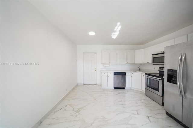 kitchen featuring white cabinetry, appliances with stainless steel finishes, and sink