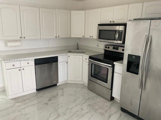 kitchen with white cabinetry, sink, and appliances with stainless steel finishes