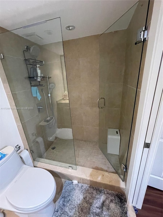 bathroom with toilet and walk in shower