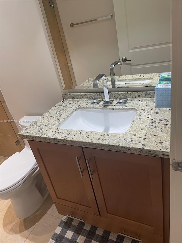 bathroom featuring vanity, toilet, and tile patterned flooring