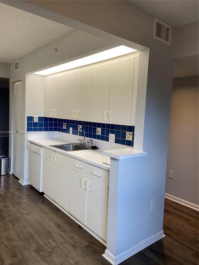 kitchen featuring white cabinetry, a textured ceiling, dark hardwood / wood-style flooring, dishwasher, and backsplash