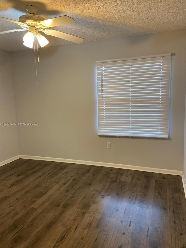 spare room with ceiling fan, dark hardwood / wood-style flooring, and a textured ceiling