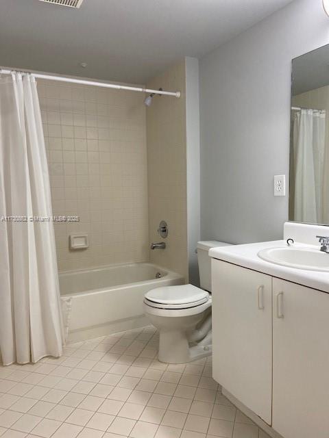 full bathroom with tile patterned flooring, vanity, toilet, and shower / bathtub combination with curtain