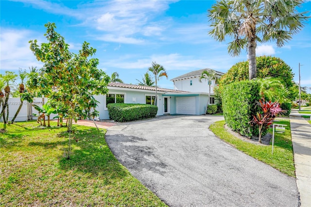 view of front of house with a garage and a front yard