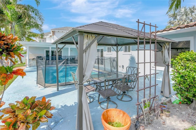 exterior space with a fenced in pool and a gazebo