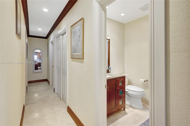 hall featuring light tile patterned flooring and ornamental molding