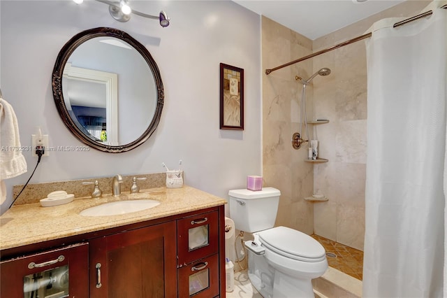 bathroom with toilet, vanity, and a shower with curtain