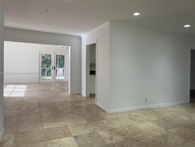 empty room with baseboards, french doors, crown molding, a textured ceiling, and recessed lighting