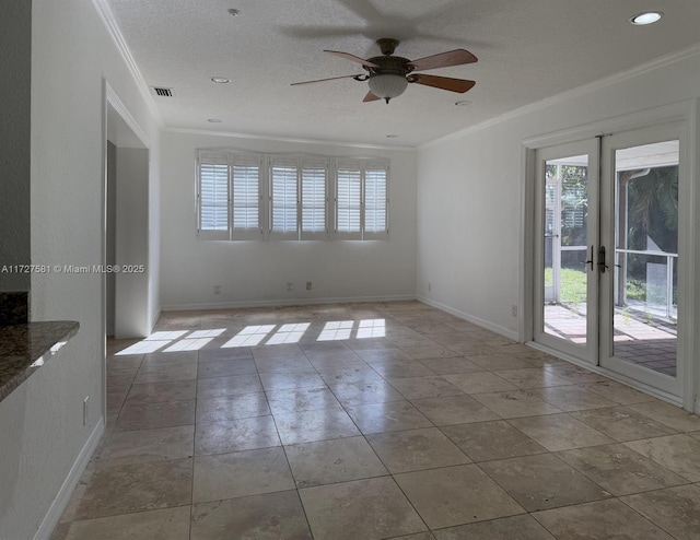 spare room featuring french doors, visible vents, ornamental molding, a textured ceiling, and baseboards