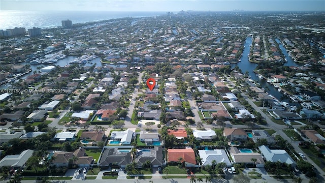 drone / aerial view with a water view and a residential view