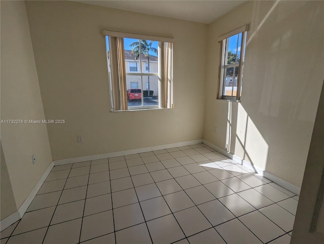 spare room featuring light tile patterned flooring