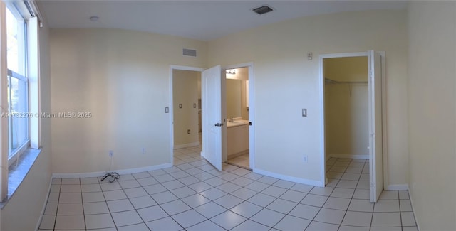 unfurnished room with light tile patterned floors and sink