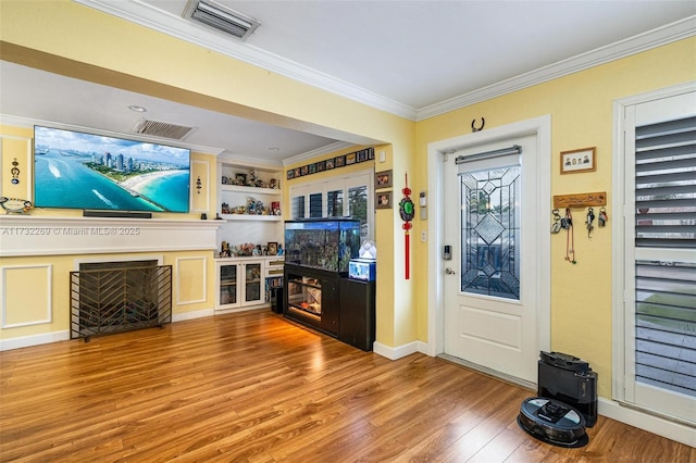 living room featuring crown molding and wood-type flooring