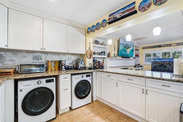 clothes washing area with light wood-type flooring, washer / dryer, and crown molding