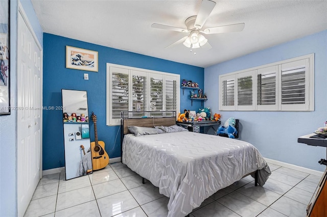 tiled bedroom with a closet and ceiling fan