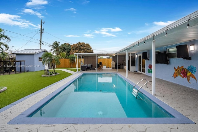 view of pool with a patio area and a yard