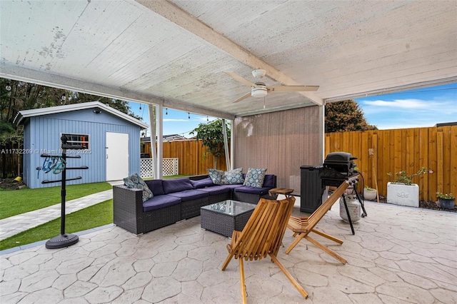 view of patio / terrace featuring outdoor lounge area, ceiling fan, and a storage shed