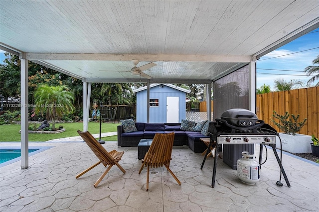 view of patio featuring grilling area, outdoor lounge area, ceiling fan, a storage shed, and a fenced in pool