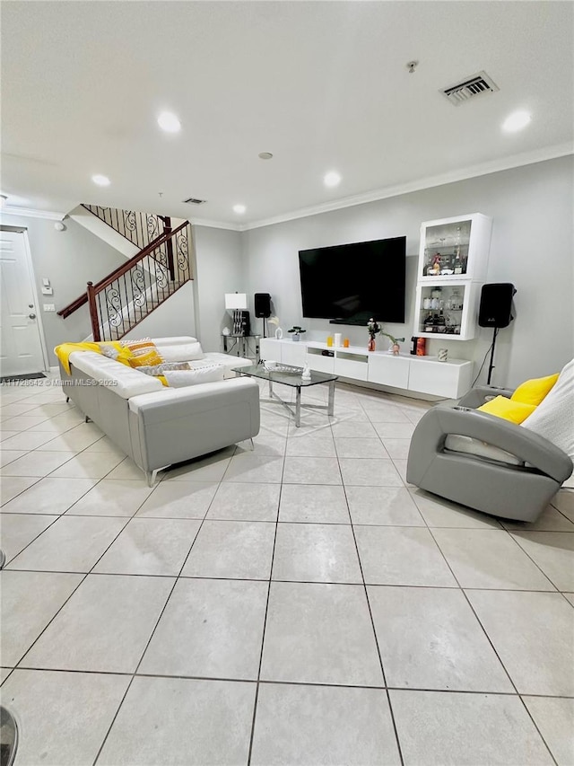 living room with built in shelves, ornamental molding, and light tile patterned floors