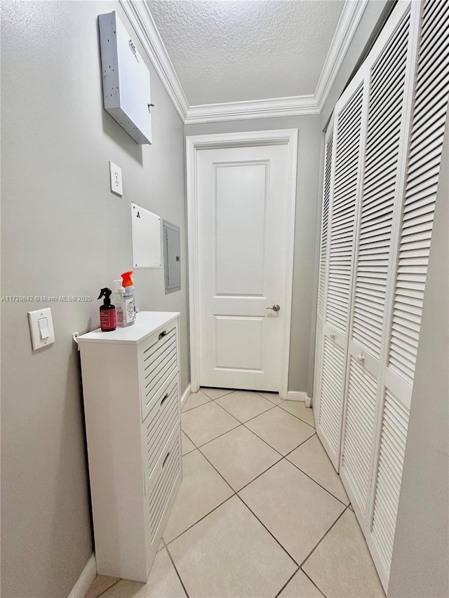 bathroom featuring crown molding, tile patterned floors, a textured ceiling, and electric panel