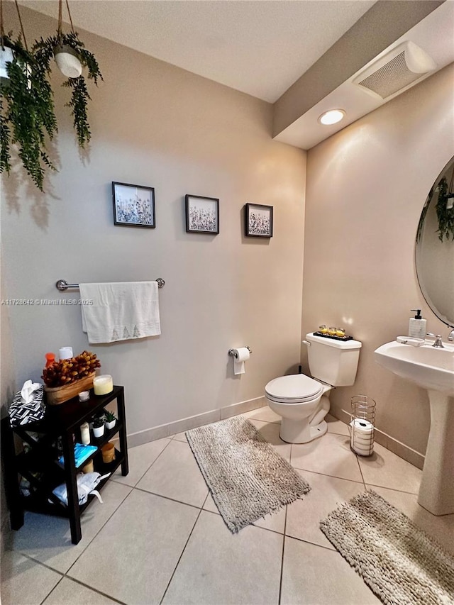 bathroom featuring sink, tile patterned floors, and toilet