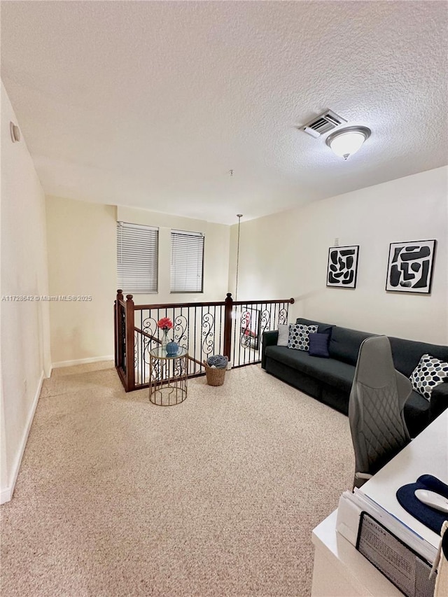 living room with carpet flooring and a textured ceiling