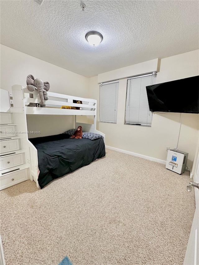 carpeted bedroom featuring a textured ceiling