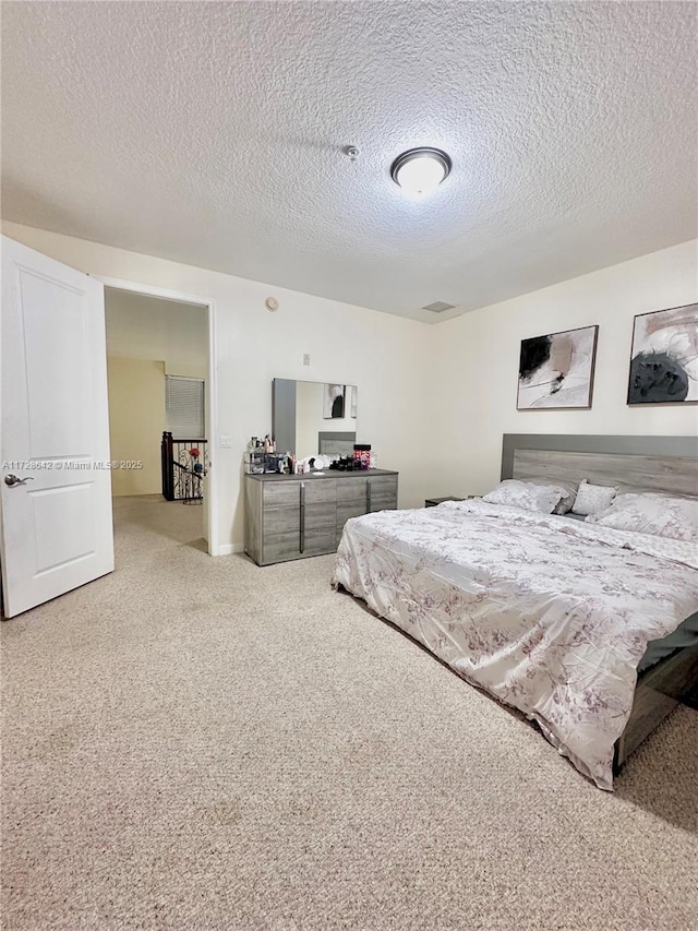 carpeted bedroom featuring a textured ceiling