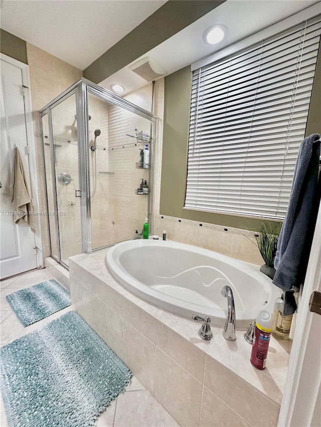 bathroom featuring tile patterned floors and separate shower and tub