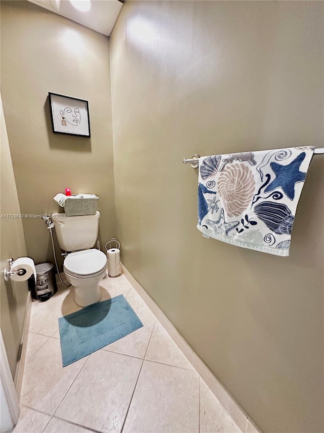 bathroom featuring toilet and tile patterned flooring