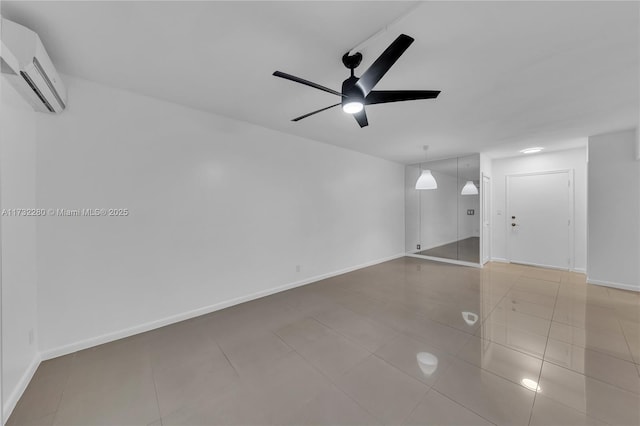 tiled empty room featuring ceiling fan and a wall unit AC