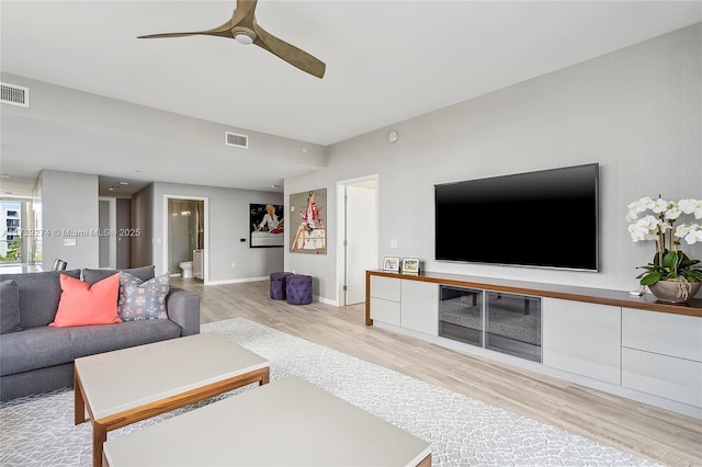 living room with ceiling fan and light hardwood / wood-style floors