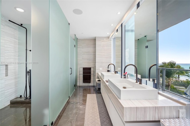 bathroom featuring vanity and a shower with shower door