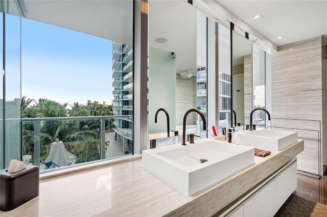 bathroom with vanity, a wealth of natural light, and tile patterned floors