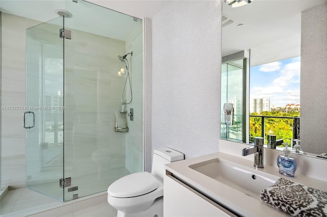 bathroom with vanity, an enclosed shower, and toilet