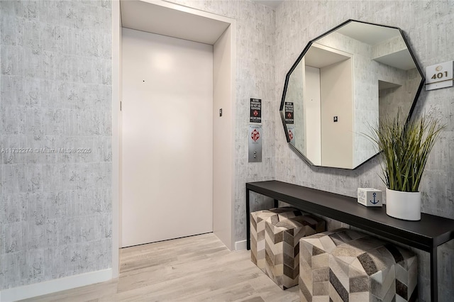 interior space featuring elevator and light wood-type flooring