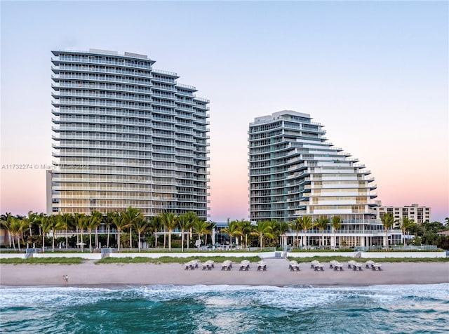 exterior space with a water view and a beach view